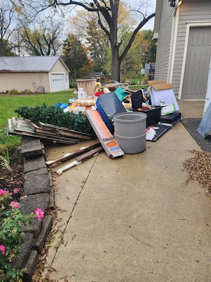 Dumpster being loaded with debris for Estate Cleanout Dumpster Rental in Kennedy